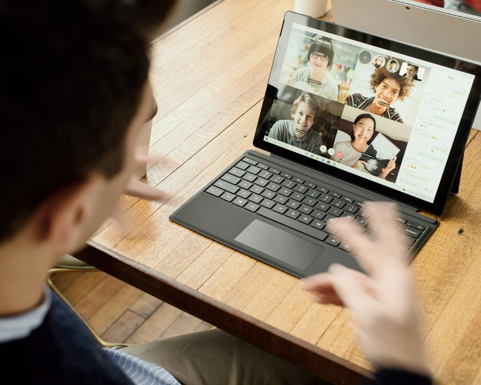 Person joining a group video call on a laptop